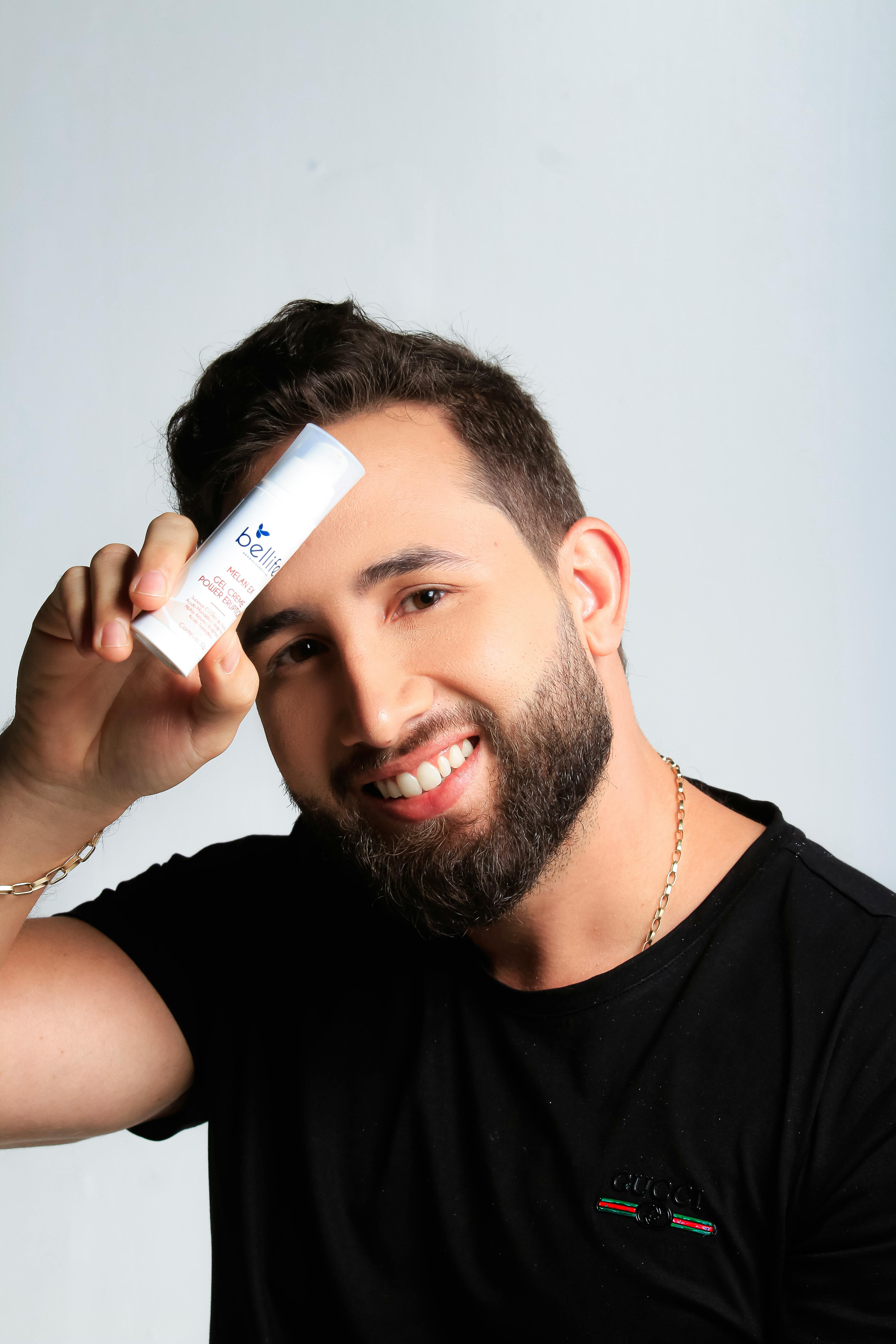 Man examining skincare product — K-beauty for all